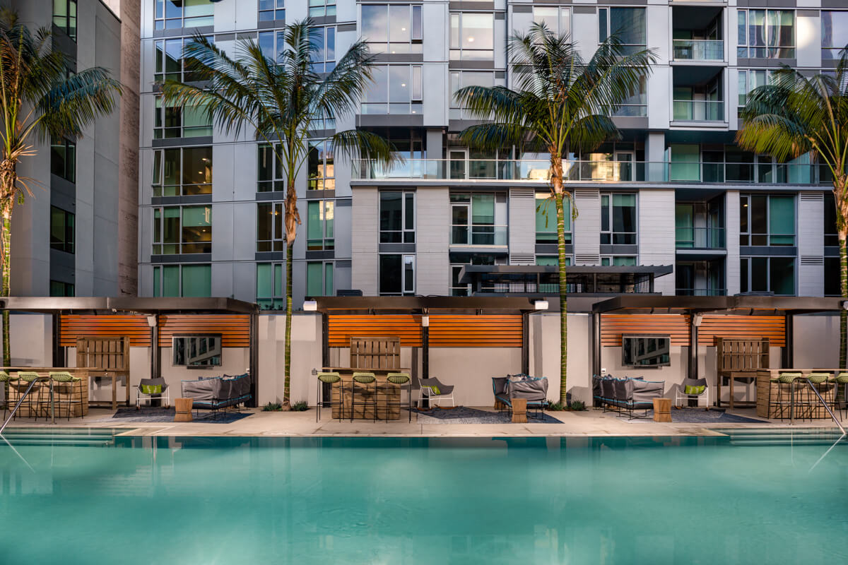 Downtown Los Angeles Apartments for Rent - Sparkling Third-Floor Swimming Pool Surrounded by LA Skyline, Private Cabanas, Umbrellas, and Comfortable Plush Lounge Chairs